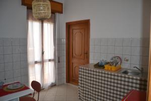 a kitchen with a table and a sink and a door at The Domus in Olmedo