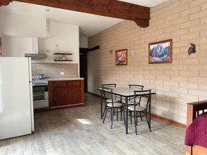 a kitchen with a table and chairs in a room at Departamento Cafayate in Cafayate