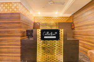 a lobby of a coffee shop with a sign on the wall at Super OYO Collection O Alambagh Formerly BM Palace in Lucknow
