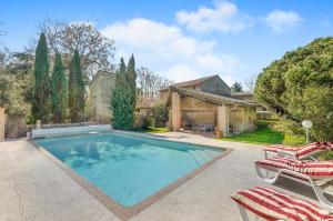 ein Swimmingpool mit zwei Stühlen und einem Haus in der Unterkunft Au bonheur des vacances in Verdun-sur-Garonne