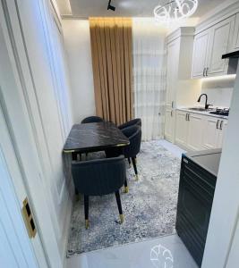 een keuken met een tafel en stoelen in een kamer bij Rent room 999 in Samarkand