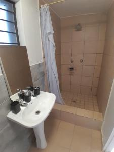 a bathroom with a sink and a shower at Mountain Vue in Hartbeespoort