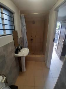 a bathroom with a shower and a sink and a shower at Mountain Vue in Hartbeespoort