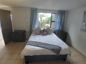 a bedroom with a large bed with a window at Mountain Vue in Hartbeespoort
