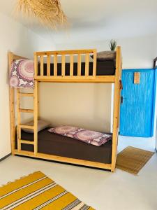 two bunk beds sitting in a room with at Surf Sun Sea Lodge in Wassane