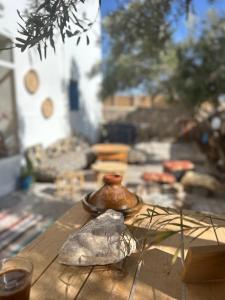 a wooden table with a vase on top of it at Surf Sun Sea Lodge in Wassane +30 photos