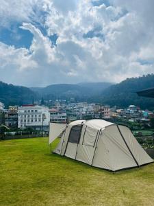 a tent sitting on top of a grass field at Ndalem Prabu Sarangan in Sarangan