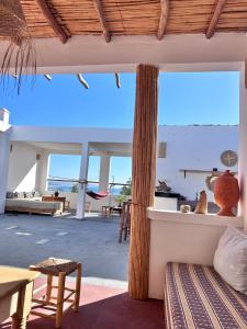 a living room with a view of the ocean at Surf Sun Sea Lodge in Wassane