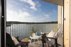 a balcony with chairs and a view of the water at 10 Cannery Row - Stunning Views - Pet Welcome - Free WiFi & Parking in Hayle