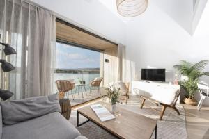 a living room with a couch and a table at 10 Cannery Row - Stunning Views - Pet Welcome - Free WiFi & Parking in Hayle
