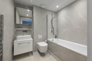 a bathroom with a toilet and a tub and a sink at 10 Cannery Row - Stunning Views - Pet Welcome - Free WiFi & Parking in Hayle +29 photos