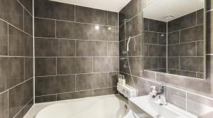 a bathroom with a toilet and a sink and a mirror at Jukdo market G1mini in Pohang