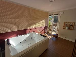 a large white bath tub in a room at Chez Jade et Zoé in Ortholès