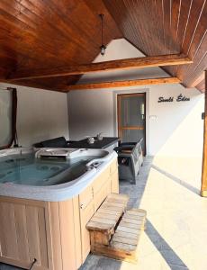 a large hot tub in the middle of a patio at Somló Éden in Somlószőlős