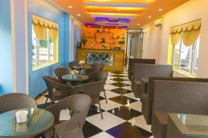 a restaurant with tables and chairs and a fireplace at 999 Hotel Lào Cai in Yên Bái