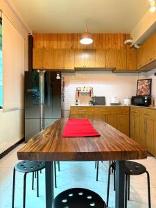 een keuken met een houten tafel en 2 krukken bij Office 3 in Bangkok