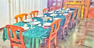 a dining room table with a blue table cloth and wooden chairs at Villagalicia360 in Bergondo