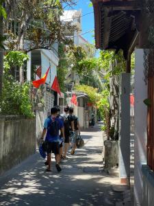 a group of people walking down a street at Tự Do Homestay Huế in Hue