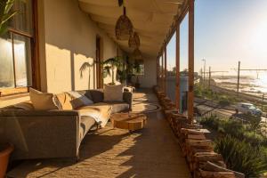 a living room with couches and a view of the ocean at Stoep By Ideas Cartel in Kalk Bay