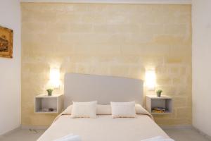 a bedroom with a white bed with two night stands at Costa Private room in Castelsardo