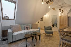 a living room with a couch and a table at Apartamenty SKI Apartments, Odkryj-Bialke in Białka Tatrzańska