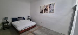 a bedroom with a bed with three pictures on the wall at city garden Kech in Marrakesh +155 photos