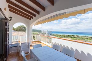 a balcony with a table and chairs and the ocean at V60A Villa Lucia in Son Bou