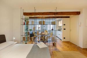 a bedroom with a bed and a dining room at Piazza Mercato14 in Domodossola
