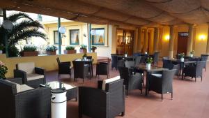 a restaurant with black chairs and tables anditures at Hotel Villa Igea in Sorrento