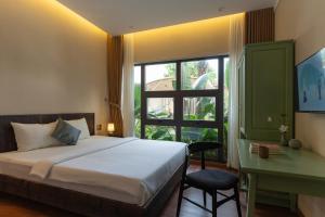 a bedroom with a bed and a desk and a window at MOONLIGHT Homestay & Hotel in Pleiku +158 photos