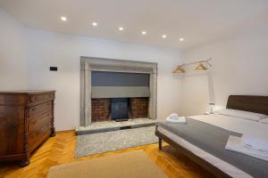 a bedroom with a bed and a fireplace at Piazza Mercato14 in Domodossola +17 photos
