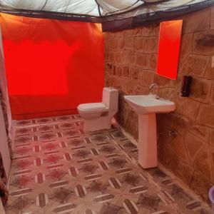 a bathroom with a toilet and a sink at Sandscapes Sam Jaisalmer by ADB Hospitality in Jaisalmer