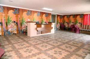 a room with a piano and a wall with flowers at Sandscapes Sam Jaisalmer by ADB Hospitality in Jaisalmer