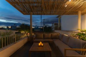 a couch on a balcony with a table at MOONLIGHT Homestay & Hotel in Pleiku +156 photos