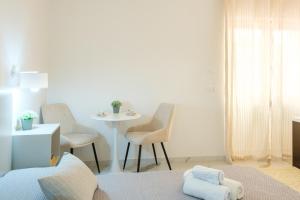 a white room with a table and chairs and a table at Costa Private room in Castelsardo +29 photos