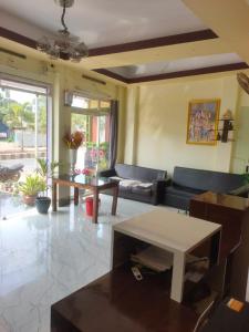 a living room with a couch and a table at Hotel Star, Agartala in Agartala