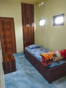 a bedroom with a bed and a wooden cabinet at Hotel Star, Agartala in Agartala