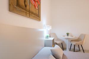 a bedroom with a bed and a table with chairs at Costa Private room in Castelsardo