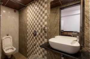 a bathroom with a sink and a toilet at CozyKey Rooms Bandra in Mumbai