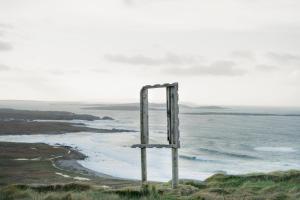 a wooden pole on the side of a beach at Carnglas, Gweedore, County Donegal in Donegal +2 photos
