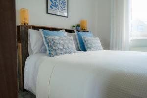 a bed with blue and white pillows on it at Carnglas, Gweedore, County Donegal in Donegal