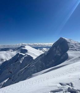 a snow covered mountain with snow on it at Jane's Resort Studio by Tatralandia & Lake in Liptovský Mikuláš