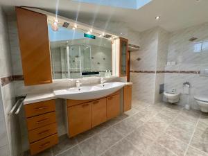 a bathroom with a sink and a toilet at Ferienwohnungen Roderer in Berchtesgaden +47 photos