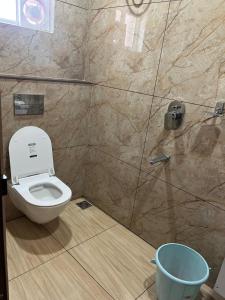 a bathroom with a toilet and a shower at Nestdormitory in Cochin