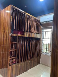 a room with a wall of wine racks at Nestdormitory in Cochin