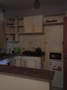 a kitchen with white cabinets and a counter top at Victorian Haven in Eldoret