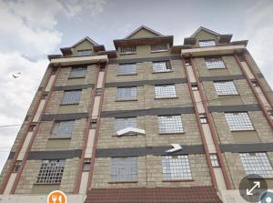a tall brick building with two arrows on it at Victorian Haven in Eldoret