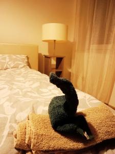 a stuffed animal is laying on a bed at Apartament z Jacuzzi in Częstochowa