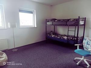 a room with two bunk beds and a chair at Apartament z Jacuzzi in Częstochowa +6 photos