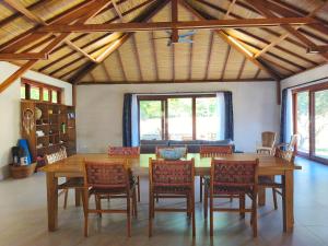 Un comedor con mesa y sillas de madera. en Villa Pesisi - 3 bdrs - beach walking distance, en Selong Belanak 13 fotos más